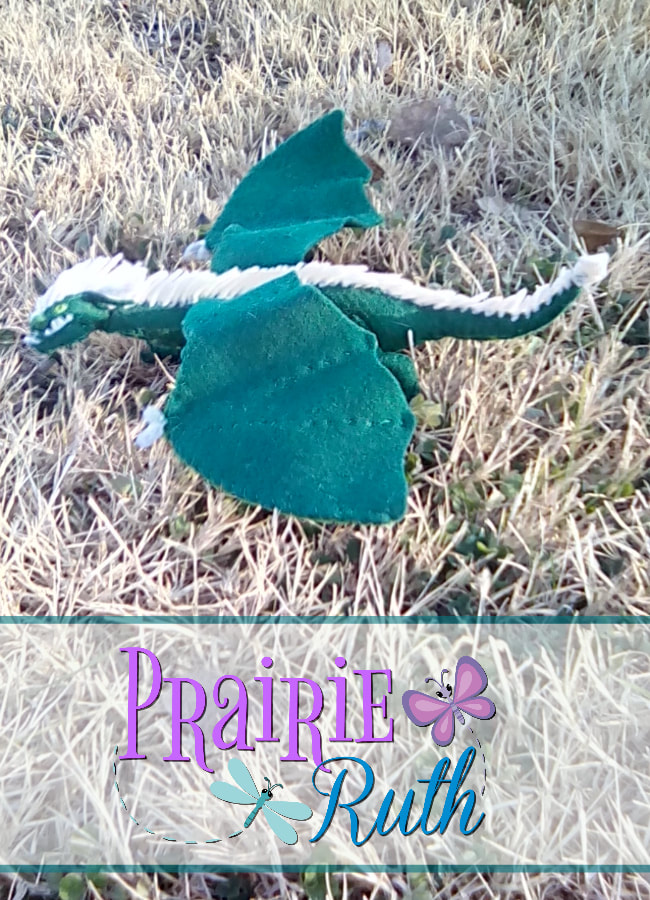 Bruik the Western mountain dragon. He is made from felt, fuzzy sticks, and needle felt.